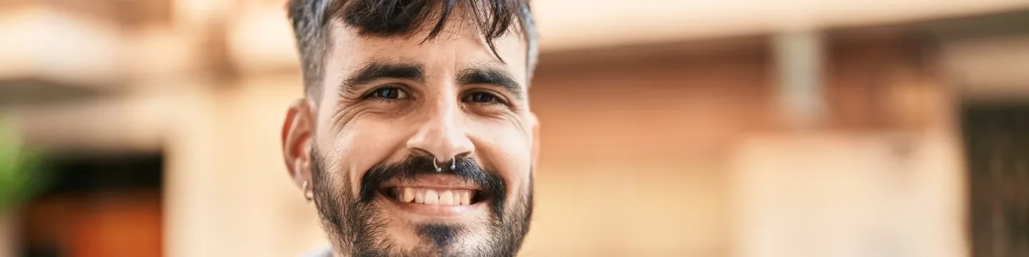 A young man with short, dark hair and a warm smile.