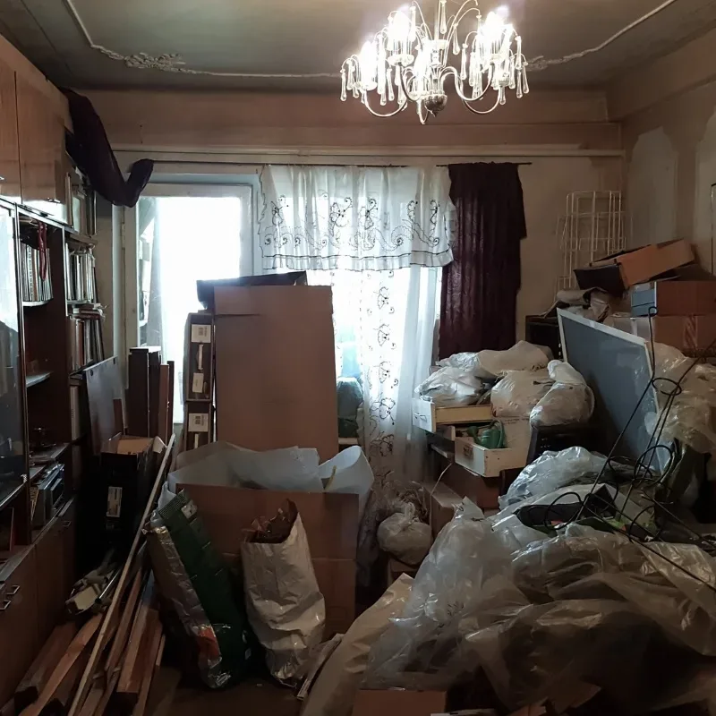 A cluttered room filled with boxes and mess.
